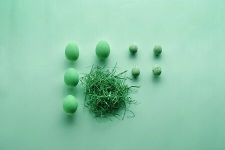 Easter eggs on a pastel green background. Easter concept in pastel colors. Top view. Flat lay....