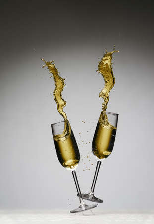 Gold champagne splash. party invitation. Table, black and white background.の写真素材