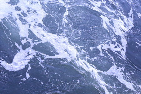 Blue water foam with white wavesの写真素材