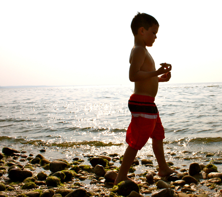summer sunset young boy beach combing のeditorial素材