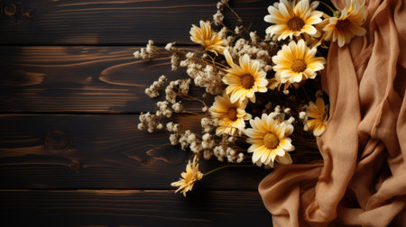 Flowers on brown wooden background. Flat lay, top view.の素材