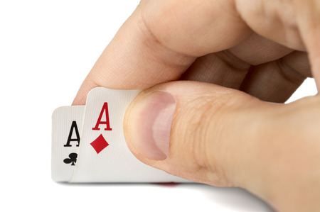 close up of man hand with pair of aces isolated over white