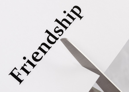 close up of paper with friendship inscription cut with scissors in twoの写真素材