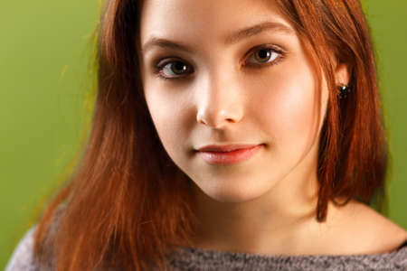 Portrait of teenage girl on green backgroundの写真素材