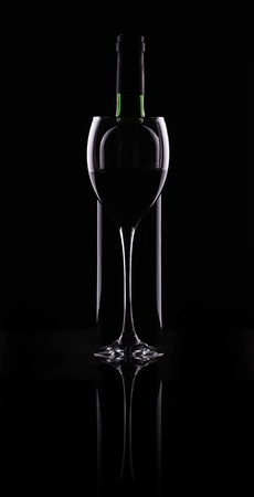 Silhouette of bottles and glasses on a black backgroundの写真素材