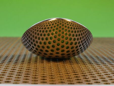 Spoon on perforated steel plate, reflecting the holesの写真素材