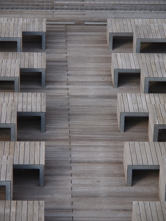 Wooden footbridge with pattern of benches and tablesの写真素材