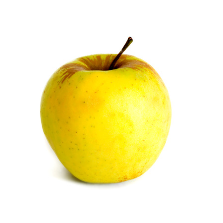 Ripe juicy yellow apple isolated on white の写真素材