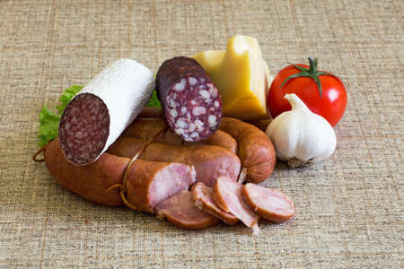 Smoked sausage with rustic food, vegetables and cheeseの写真素材