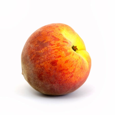 Ripe juicy single peach isolated on white backgroundの写真素材