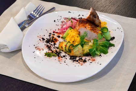 Roasted pork meat with vegetables and rice served in restaurantの写真素材