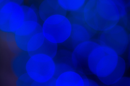 Blue bokeh background created by electic christmas lightsの写真素材