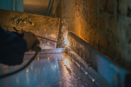 Process of welding with sparks and flame