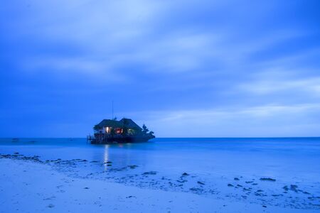 Rock romantic restaurant in Indian ocean near Zanzibar coastlineの写真素材