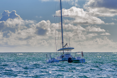 Scenic ocean view with beautiful tropical coastline and sailing vesselの写真素材