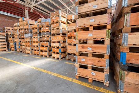 Large storehouse and many rows of wooden containersの写真素材