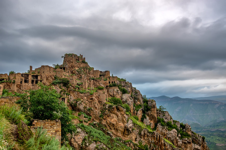 Abandoned village Gamsutl in Dagestan. Scenic landscape with ruins of lost city in mountainsの写真素材
