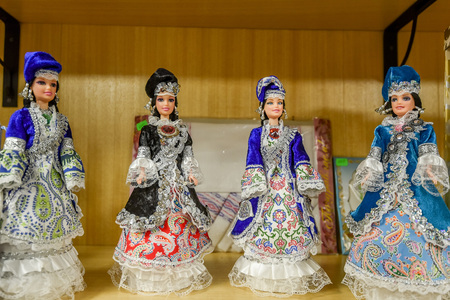 Collection of souvenir dolls in traditional tatar dresses on marketplace
