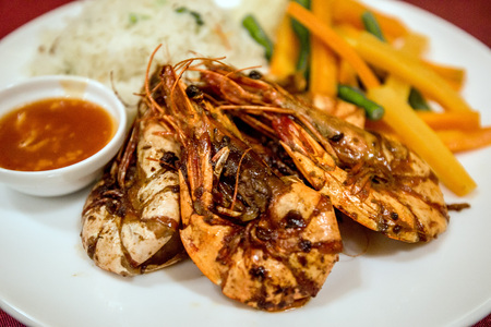 Close up of prawn with rice, vegatables and sauceの写真素材