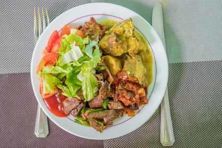 Meat and fish with vegetables and curry sauceの写真素材