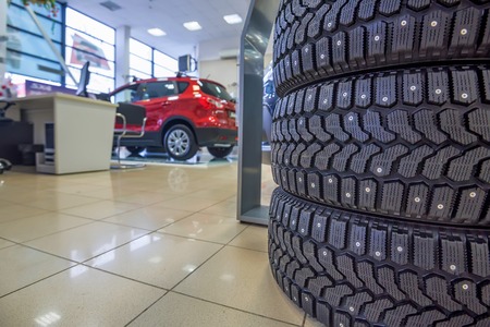 Studded new winter tires in showroom of a car dealerの写真素材