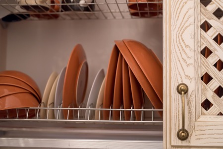 Dishes in kitchen cupboardの写真素材