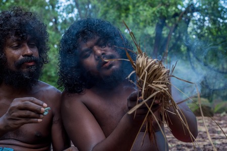 DABANA, SRI LANKA - CIRCA DECEMBER 2016: Vedda men making fire. Veddas are an indigenous people of...