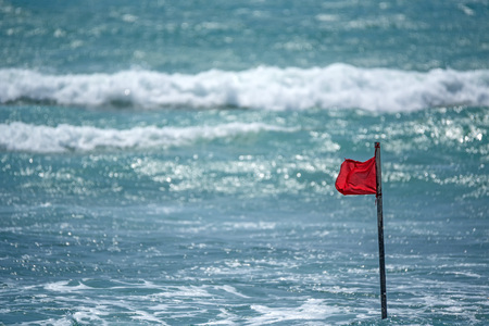 Red warning flag on beach