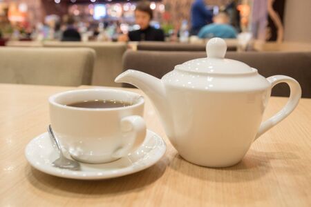 Teapot and cup of tea in cafeの写真素材