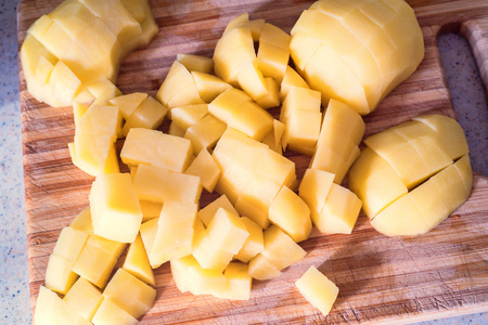 Cutting raw potatoの写真素材