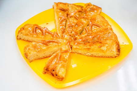 Yellow cake with pieces cut offの写真素材