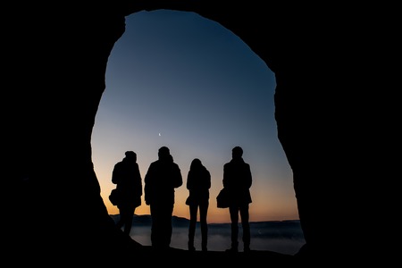 Group of travelers in mountains at night