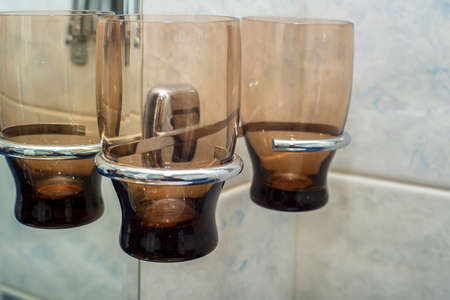 Empty glasses for toothbrush in bathroomの写真素材