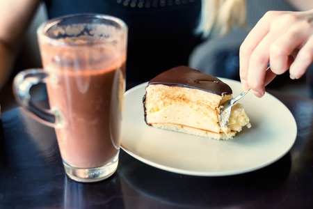 Eaing souffle cake with spoon in cafeの写真素材