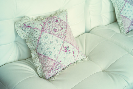 Decorative cushion on white leather sofaの写真素材