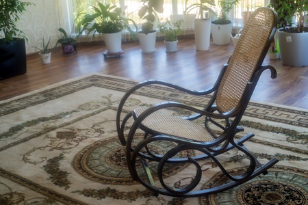 Brown wicker rocking chair in hallの写真素材