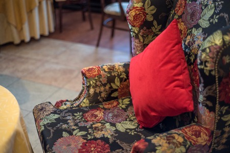 Red cushion on vintage armchairの写真素材