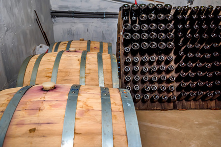 Wine casks and bottles in cellar
