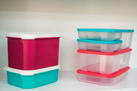 Group of modern plastic food containers on shelfの写真素材