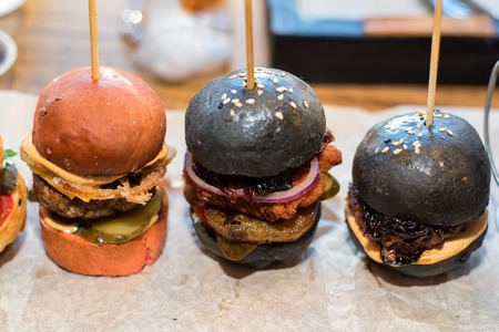Homemade minihamburgers with black bunsの写真素材