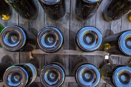 Bottoms of wine bottles close upの写真素材