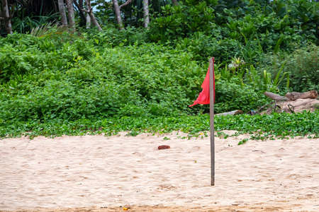 Red warning flag on beach
