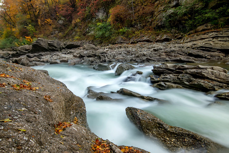 Fall landscape with mountain river and forest