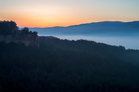 Beautiful view of misty sunrise in mountains