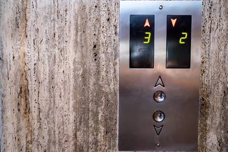 Close up modern elevator call buttons and screenの写真素材