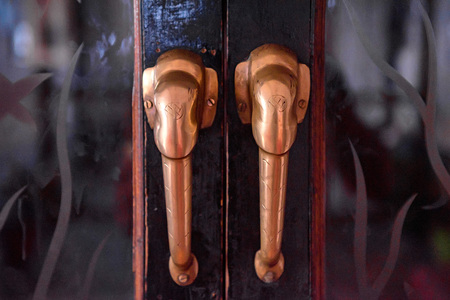 Old doorknob on vintage red door in India