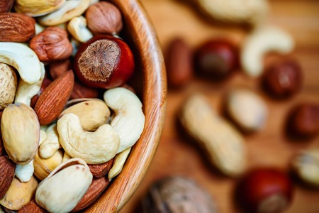 Assorted nuts in wooden bowlの写真素材