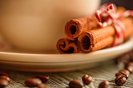 Cinnamon stick and cup of hot drinkの写真素材