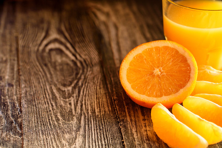 Oranges and orange juice on a wooden backgroundの写真素材