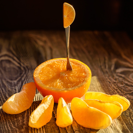 Ripe juicy fresh oranges, whole, cut and slicesの写真素材